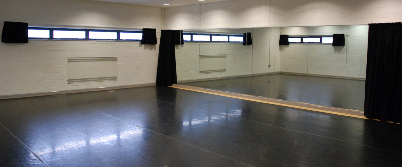 The inside of the Dance Studio facing the mirrored wall on the right and the horizontal external windows to the left.